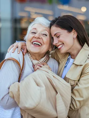 Elderly mother and daughter hugging