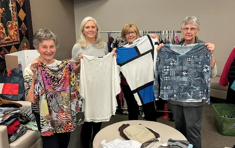 Volunteers setting up a clothing sale