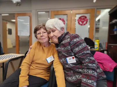 Two seniors smiling at Adult Day Program event