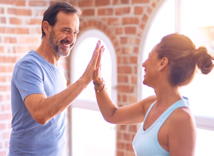 man and woman high fiving