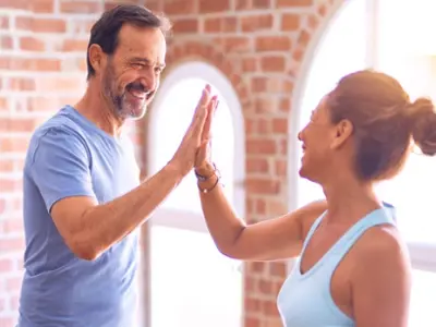man and woman high fiving